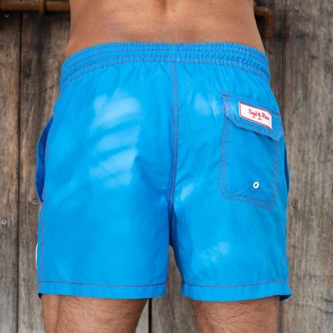 Syd & Rex Solid Rock men's swim trunks in Royal — back view showing print detail