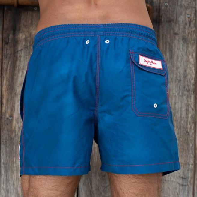 Syd & Rex Solid Rock men's swim trunks in Blue — back view showing print detail