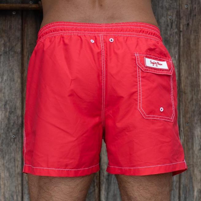 Syd & Rex Solid Rock men's swim trunks in Red — back view showing print detail