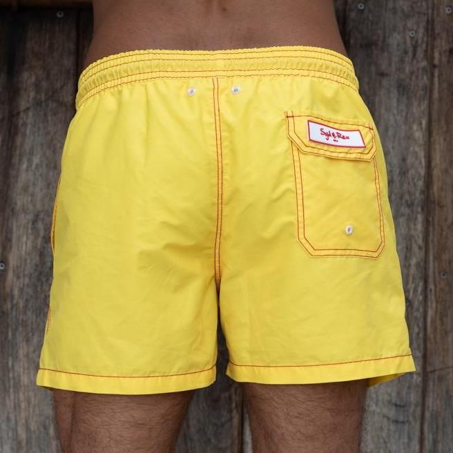 Syd & Rex Solid Rock men's swim trunks in Yellow — back view showing print detail