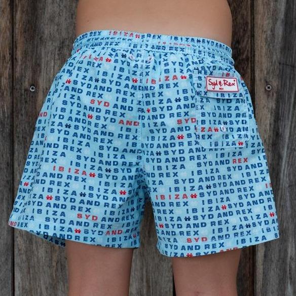 Syd & Rex Words boys' swim trunks in Sky — back view showing print detail
