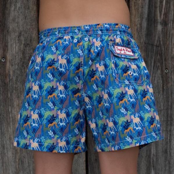 Syd & Rex Party Dogs boys' swim trunks in Royal — back view showing print detail