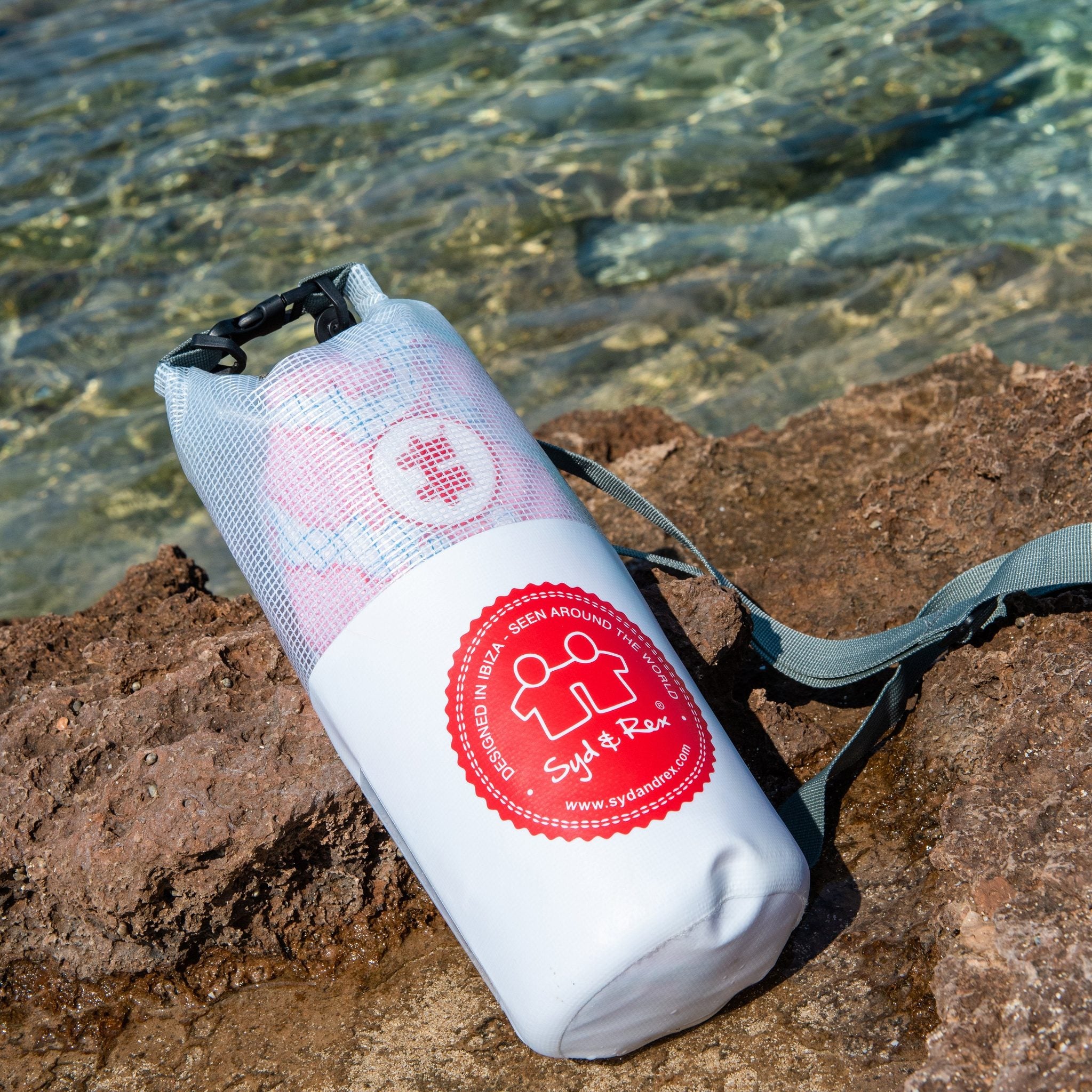 Syd & Rex Mambo Ibiza Tiles swim trunks in White worn poolside in Ibiza — men's sustainable beachwear